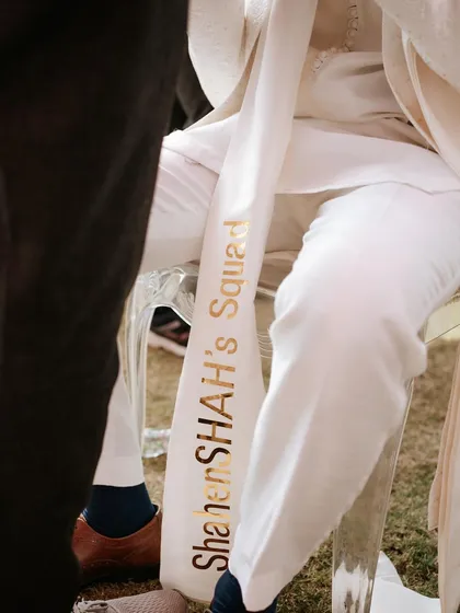 A custom stole for a member of the groom's squad, embroidered with 'ShahenSHAH's Squad'. A fun and personal touch for the wedding party.