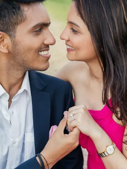 A close-up of the couple during their pre-wedding shoot. Her makeup is soft and natural, with a focus on creating a romantic and intimate feel.