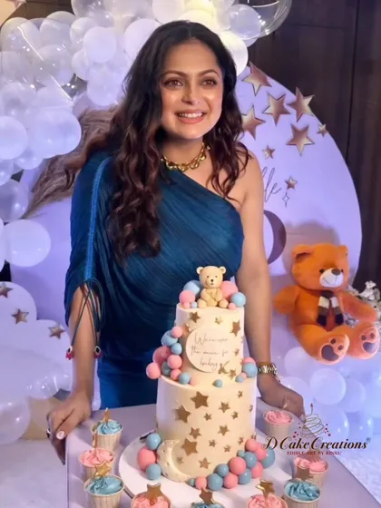 The radiant mom-to-be, Drashti Dhami, with her adorable baby shower cake and matching cupcakes.