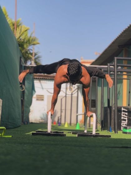 A full planche on parallettes. This is a peak static skill that takes years of dedicated training to achieve.