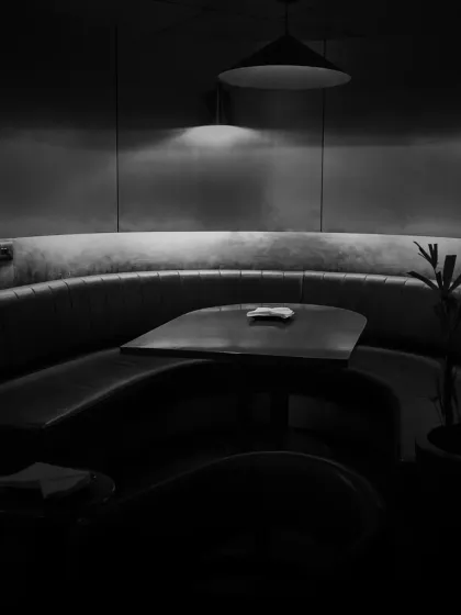 We believe in shadowed complexity beneath pristine simplicity. This curved booth seating offers a private nook for you and your guests to settle in for the evening.