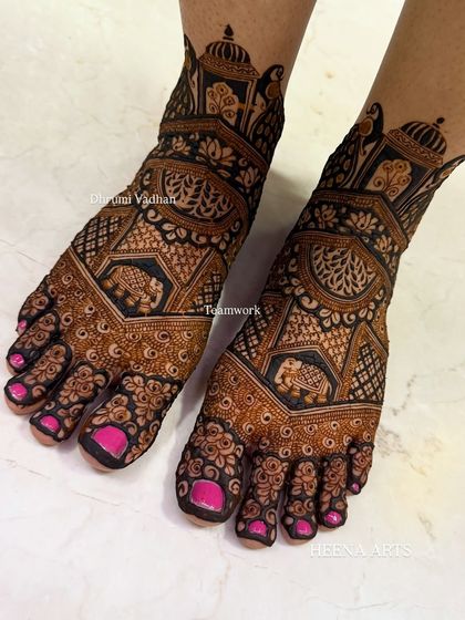 This bridal foot design features bold, traditional motifs, including elephants within geometric frames. The dark stain makes the intricate details stand out beautifully.