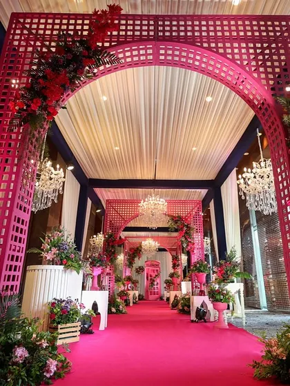 A wider view of the pink-themed entrance, showing the grand scale and the dramatic effect of the monochromatic color scheme.