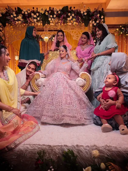A beautiful moment of the bride surrounded by her family and friends.
