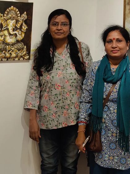 Standing with a friend next to my Panchaloha Ganesha painting at the exhibition.