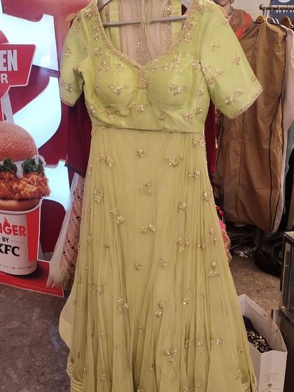 A lovely lime green Anarkali-style lehenga with a short-sleeve embellished blouse. This fresh and vibrant color is perfect for a mehendi ceremony or a summer wedding.