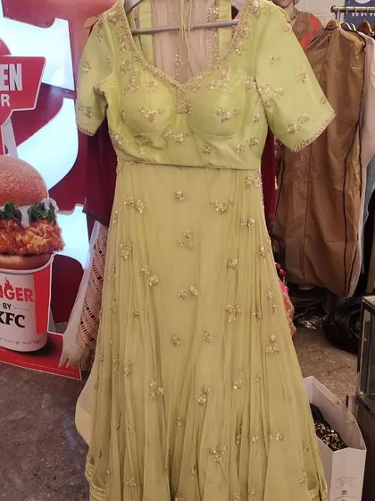 A lovely lime green Anarkali-style lehenga with a short-sleeve embellished blouse. This fresh and vibrant color is perfect for a mehendi ceremony or a summer wedding.