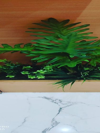 A small planter with a philodendron-style artificial plant. This is great for placing on top of cabinets or on shelves.