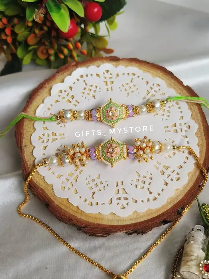 A beautiful pastel green and purple meenakari Rakhi set for your brother and sister-in-law.