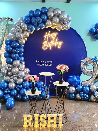 The full setup for the 9th birthday, including a circular backdrop and light-up name.
