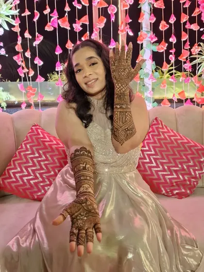 Showing off her beautiful bridal henna. The design extends up the arms, creating a seamless flow of art that looks incredible from every angle.
