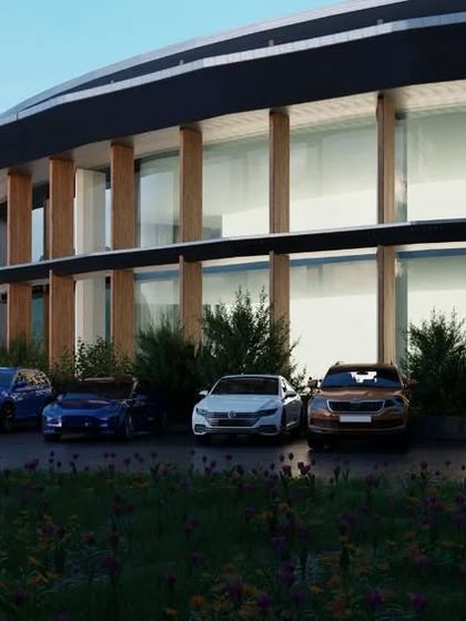 A view of the parking area and entrance of the circular building. The design shows how even functional areas can be integrated into a cohesive and aesthetically pleasing architectural vision.