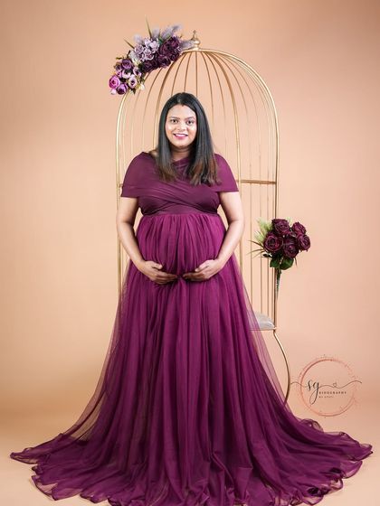 A joyful and confident solo portrait. The mom-to-be looks directly at the camera, her happiness radiating from the image.