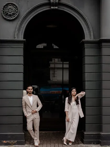 This image embodies modern elegance. The couple's coordinated style, combined with the strong architectural lines of this urban location in Mumbai, creates a sophisticated and contemporary pre-wedding portrait that is both chic and powerful.