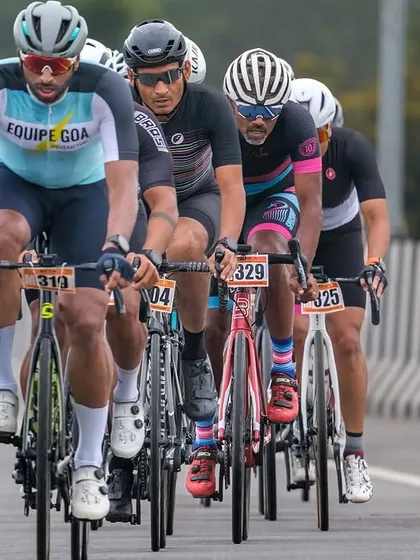 A group of masters riders, showing intense focus and teamwork as they race together.