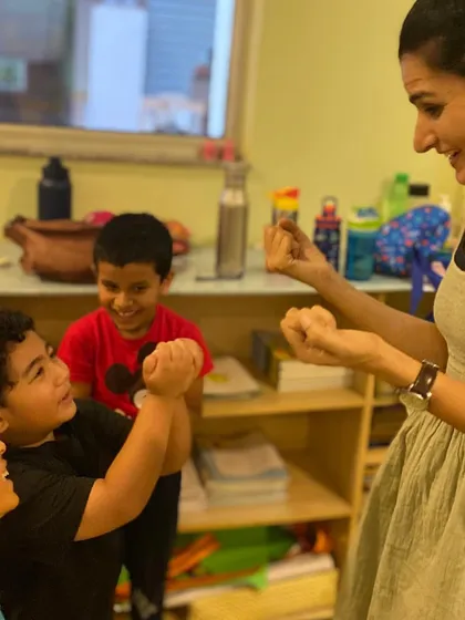 A moment of fun and connection during a classroom exercise. Building a positive and supportive environment is key to unlocking creativity.