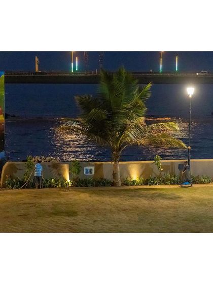 The landscape at the Gora Dabkal ground by night, with the illuminated sea-link providing a dramatic backdrop. Thoughtful lighting extends the usability of the park, making it a safe and beautiful asset for the community after dark.