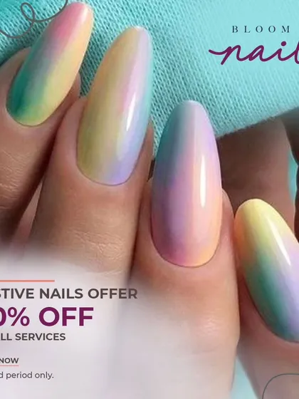 A full view of the hand with the pastel rainbow ombré nails, showing how they look against a light background.