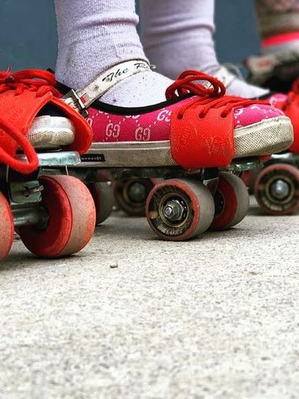 The journey begins here. A lineup of our beginners' skates, ready for class. These red wheels are the first step to a lifetime of skating.