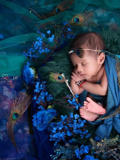 A close up of our little Krishna, adorned with peacock feathers and surrounded by deep blue flowers. I focus on capturing the peaceful expression and tiny details that make your baby's portrait so special.