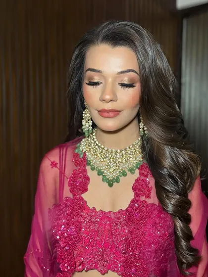 A close-up of Tanisha's eye makeup, with her eyes closed to show the seamless blending of warm, sultry tones.