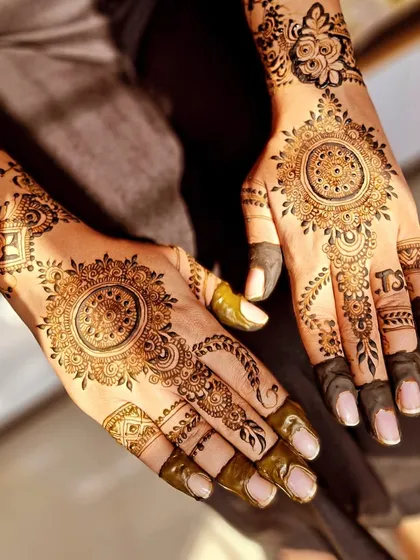 Another angle of the elegant mandala design for an engagement, showing how the pattern flows beautifully onto the fingers.