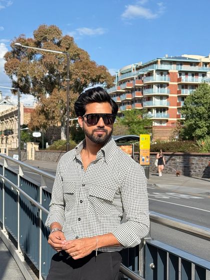 The check shirt seen in a bright, urban setting, showcasing its adaptability from day to night.