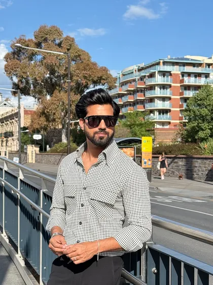 The check shirt seen in a bright, urban setting, showcasing its adaptability from day to night.