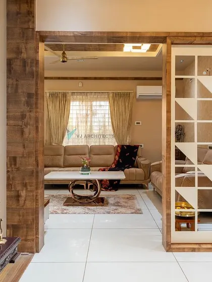 The geometric screen acts as a beautiful, semi-private divider. It separates the main living area from other parts of the home without closing it off completely, maintaining an open and airy feel.