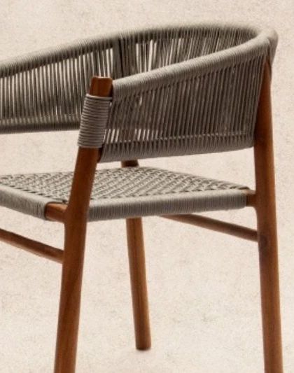 The 'Tali' chair, a comfortable and stylish piece with a teak frame and grey woven rope. Its curved back provides excellent support.