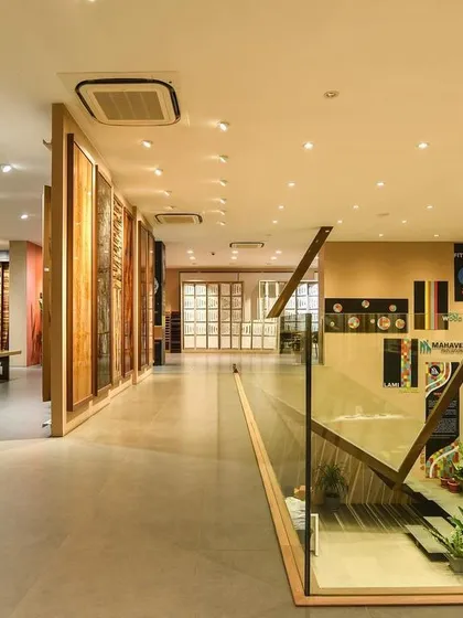A comprehensive look at a conventional commercial space, highlighting the double-height reception, glass-walled mezzanine, and various product display areas designed for a modern business.
