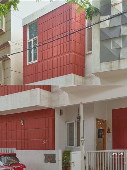 A closer look at the exterior materials of the Raghavendra Residence, highlighting the clean lines and bold color choices.