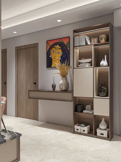 A beautiful console and shelving unit designed for an entryway or living space. The combination of wood, light-colored laminates, and a striking piece of Indian art creates a welcoming and culturally rich vignette.