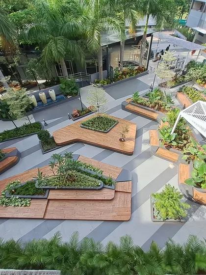 This aerial view showcases the scale and complexity of our landscaping for the Atria University campus. We designed a network of interconnected public spaces with custom-built wooden deck seating, integrated planters, and thoughtful pathways to foster community and relaxation.