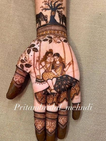 A romantic depiction of Lord Shiva and Parvati on a swing, a common theme for Teej and Sawan festivals. The details in their clothing and the surrounding nature are all done with henna.