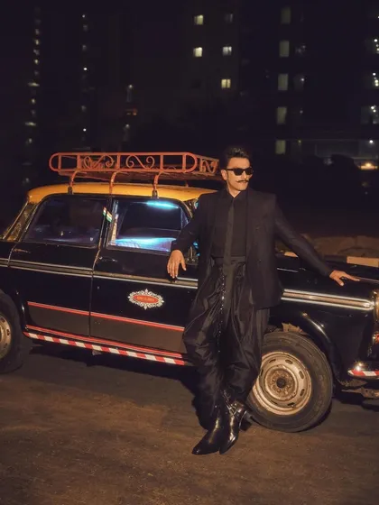 Another angle of Ranveer's powerful look. The styling is confident and edgy, perfectly matching his dynamic personality. This is a great example of modern celebrity menswear.