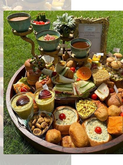 A cozy and inviting pre-plated chai platter. This board features a variety of sandwiches, bread rolls, and dips, making it a perfect companion for a relaxed evening with friends.