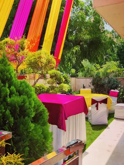Another view of the outdoor seating, showing how I arrange tables and chairs among the existing greenery to create a pleasant environment for guests.