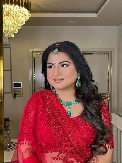 Another angle of this beautiful bride in red. The look is timeless, featuring classic eye makeup and a flawless complexion that lets her natural beauty shine.