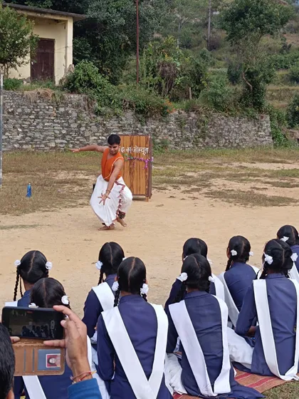 Demonstrating a Bharatanatyam pose for students during a SPIC MACAY workshop. It is incredibly rewarding to see their curiosity and enthusiasm as they learn about hand gestures (*mudras*) and the stories behind them.