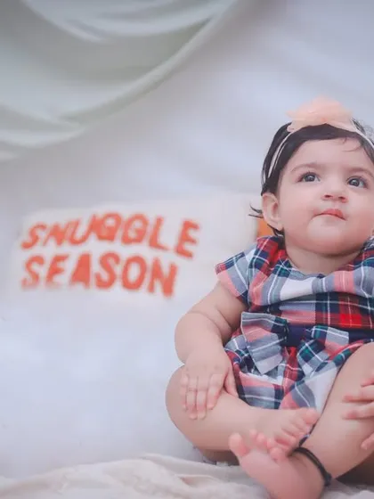 This little one is sitting among fluffy clouds, looking up curiously. Our themed shoots are designed to be both beautiful and engaging for children.