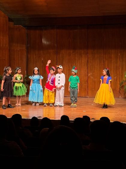 Aladdin waves to the audience, surrounded by his fellow fairytale characters.