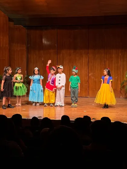 Aladdin waves to the audience, surrounded by his fellow fairytale characters.
