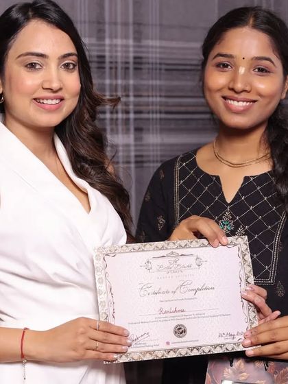 A happy student on her graduation day, certificate in hand.