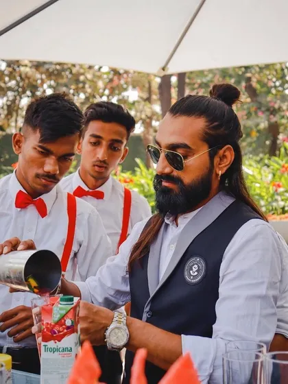 Teaching the next generation. Here I am, showing my team members the art of a perfect pour, ensuring our standards of quality are always met.