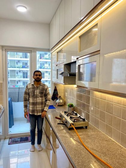 Standing in the completed parallel kitchen, a testament to our commitment to quality and design.