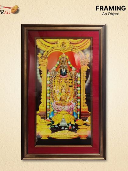 This depiction of Tirupati Balaji is framed to become the centerpiece of a home mandir. The antique brown and gold frame, paired with a raw silk mount, adds to the sense of divinity and tradition.