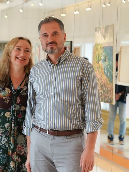 Artist Aleksandr Ibragimov with a guest at his solo show.