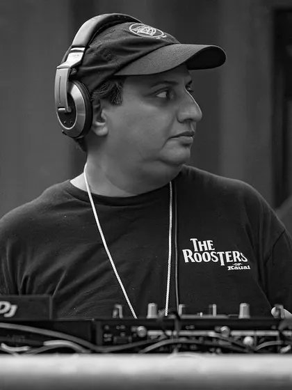 A focused, black and white shot of me at the decks. DJing for a large festival crowd requires intense concentration to read the room and keep the energy flowing.