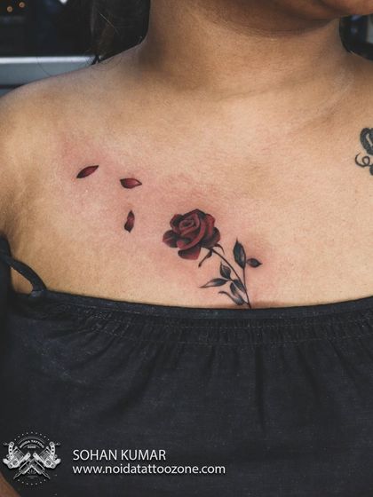 A classic red rose tattoo on the chest. The deep red color and delicate shading on the petals give this piece a timeless and romantic feel.